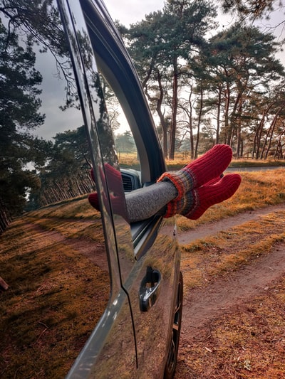 Dressed in a red sweater and a red pants with black steering wheel
